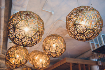 Close up many yellow lamp in cafe at night.