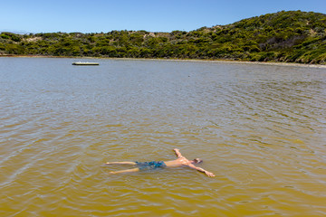 Fototapeta na wymiar Man floating like dead in a salt sea, south Australia