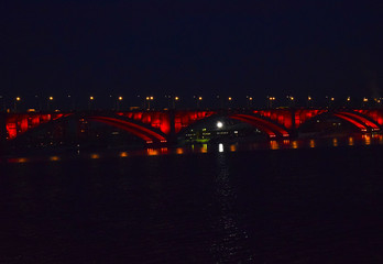 Obraz premium Night bridge over the Yenisei river. Reflection of lights in water. The sights of the city of Krasnoyarsk.