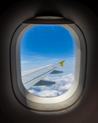 Fototapeta na wymiar the wing of the aircraft in the window