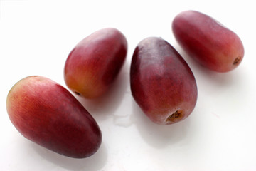 Red grape  on white background. individual berries