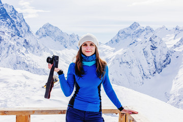 Happy girl traveler at the top of the mountains.
