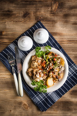 Fillet of chicken legs with stewed vegetables.