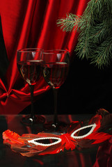 Two glasses of red wine, carnival mask