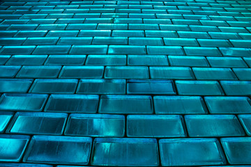 Stacks of glass blocks illuminated from the back with blue light.