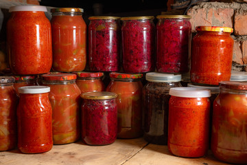 Canned vegetables in glass transparent jars.