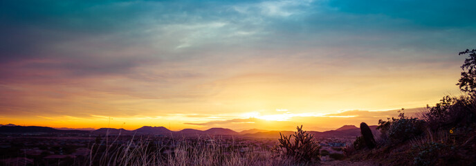 A panorama of a colorful sunset over the desert of the American Southwest in Arizona.