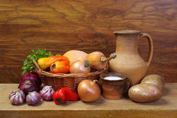 Potatoes, onions, garlic, a cup of milk and a jug. 