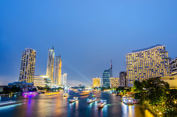 Fototapeta na wymiar Cityscape of boat light trails on Chao Phraya River night scene in Bangkok, Thailand.