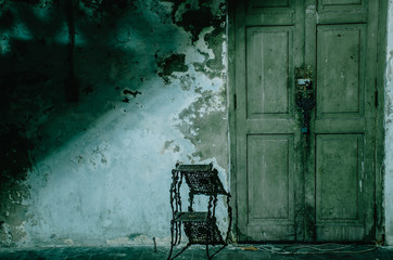 Naklejka premium Dark and scary front house entrance door at night, copy space.