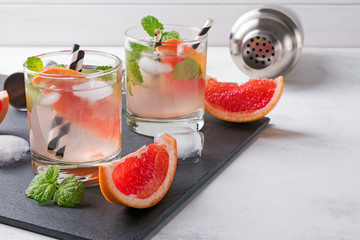 Two glasses of grapefruit cocktail with mint close-up