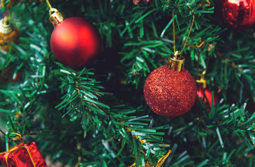 Christmas decoration. Hanging red balls on pine branches christmas tree garland and ornaments. with copy space