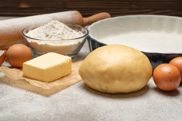 unrolled and unbaked Shortcrust pastry dough recipe on concrete background