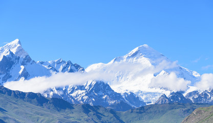 Fototapeta na wymiar Jammu-Kashmir landscape with snow peaks and blue cloudy sky in background in India