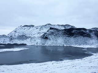 frozen lake near the snowy mountains