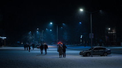 people walking in city at  winter night