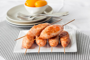 Minced turkey kebabs on square white plate