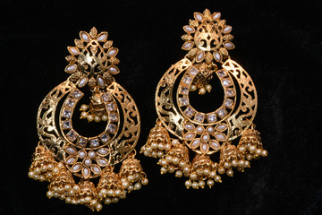 Fancy golden earrings for woman fashion closeup macro image