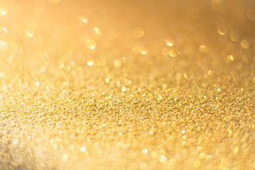 Defocused gold glitter background. Gold abstract bokeh background. Christmas abstract background