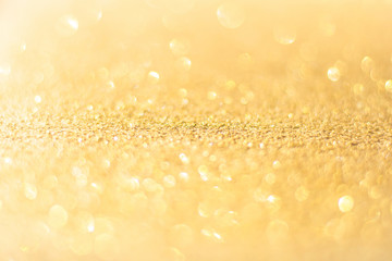 Defocused gold glitter background. Gold abstract bokeh background. Christmas abstract background