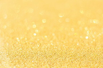 Fototapeta na wymiar Defocused gold glitter background. Gold abstract bokeh background. Christmas abstract background