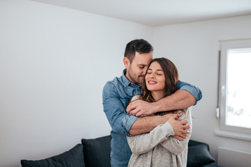 Fototapeta premium Affectionate couple hugging at home.