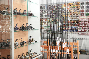 Fishing equipment in sports shop. Recreational activity © New Africa