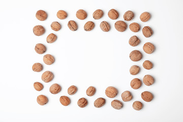 Frame made with walnuts and space for text on white background, top view