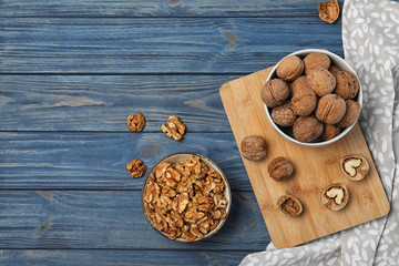 Flat lay composition with walnuts and space for text on wooden background
