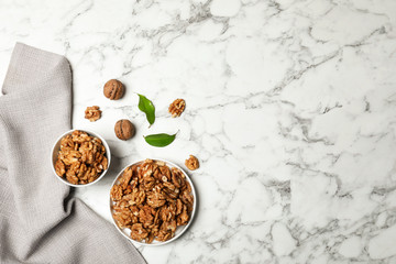 Flat lay composition with walnuts and space for text on marble background