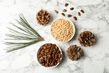 Flat lay composition with pine nuts on marble background