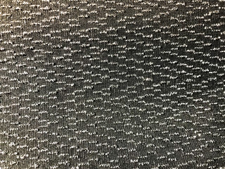 Texture of black synthetic fabric with beautiful silvery dots sparkles. The background