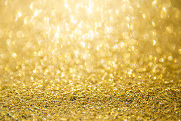 Defocused gold glitter background. Gold abstract bokeh background. Christmas abstract background