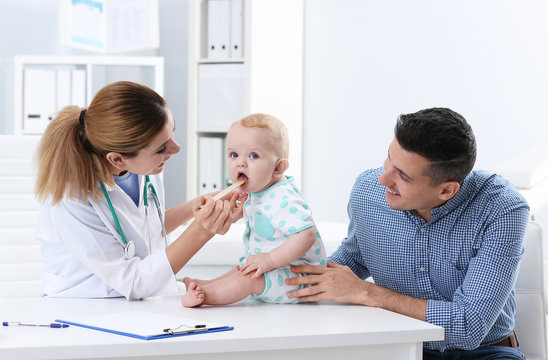 Man with his baby visiting children's doctor in hospital