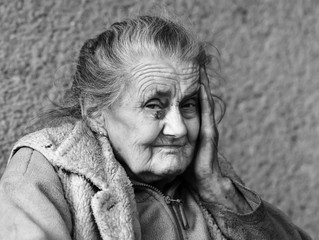 Very old and tired wrinkled woman outdoors