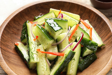 Delicious cucumber salad with onion and pepper on plate, closeup