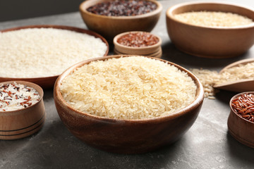 Brown and other types of rice on grey table