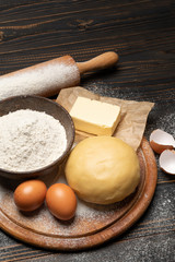unrolled and unbaked Shortcrust pastry dough recipe on wooden background