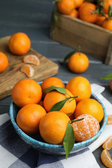 Fresh ripe tangerines in bowl on table