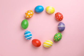 Decorated Easter eggs and space for text on color background, top view