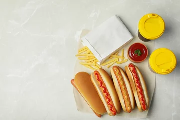  Tasty hot dogs, french fries and drinks on table, top view. Space for text © New Africa