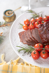 Sliced roast beef with cherry tomatoes and mustard sauce