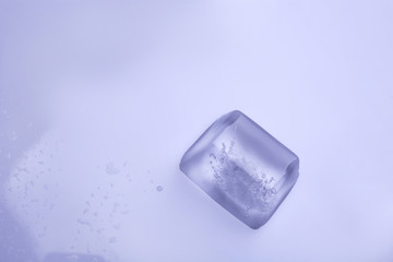 Ice cube on color background. Space for text