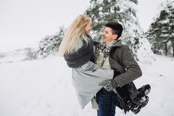 Happy Couple Having Fun Outdoors in Snow Park.