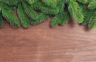 Christmas background. Fir tree branches and pine cones with decoration on a wooden board. with copy space for text.