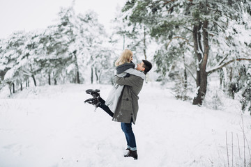 Happy Couple Having Fun Outdoors in Snow Park.