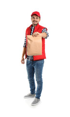 Young courier with paper bag on white background. Food delivery service