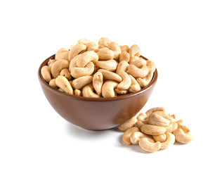 Tasty cashew nuts in bowl isolated on white