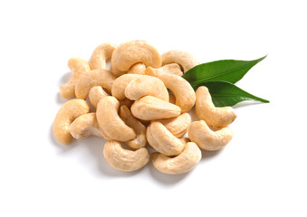 Fototapeta premium Tasty cashew nuts with leaves isolated on white