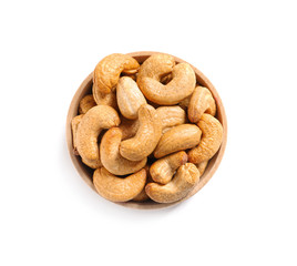 Tasty cashew nuts in bowl isolated on white, top view
